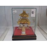 eastern yellow and white metal model of a temple