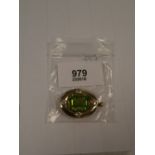 Oval 9ct gold brooch pendant set with large central peridot and 4 diamonds