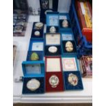 Collection of 10 Boxed Halcyon Days and Bilston enamel pots and eggs plus an unboxed example
