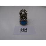 Chinese silver ornate ring in the form of a dragon with coral eyes holding a turquoise cabouchon