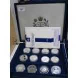 Case containing collection of 12 Commemorative silver proof coins relating to The Queen Mother