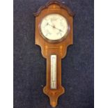 A mahogany barometer by Blooms Ltd, having shaped moulded cornice above a boxwood & ebony floral