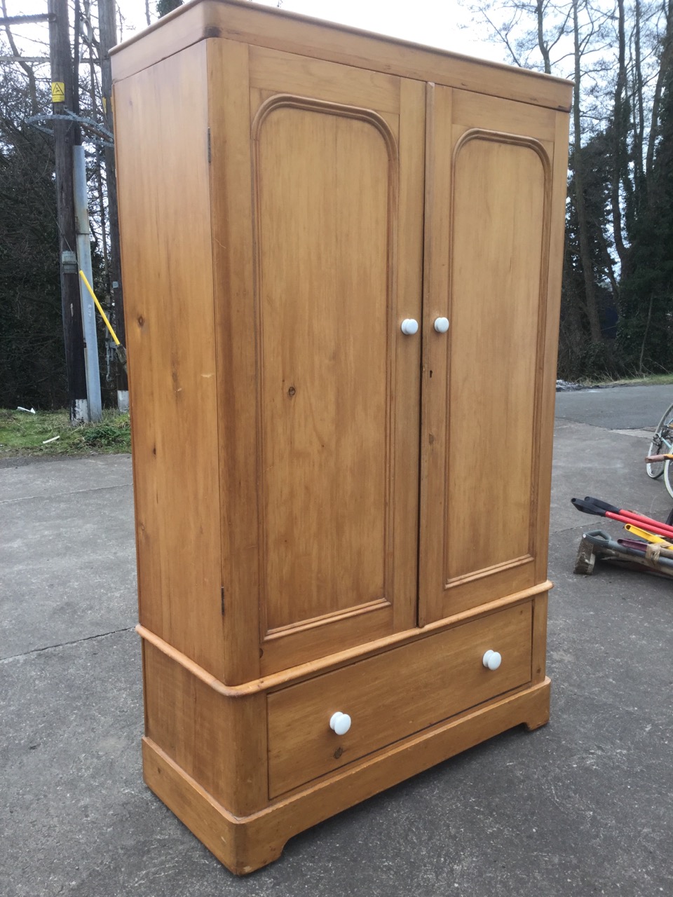 A Victorian pine wardrobe, having plain cornice above a pair of arched panelled doors mounted with - Image 2 of 3