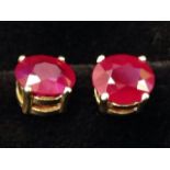 A pair of 18ct yellow gold ruby stud earrings, the oval claw set rubies of over 2.5 carats. (2)