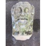 A large eighteenth century carved stone gargoyle, the head with scrolled surround carved complete