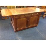 A nineteenth century Gillow style architects desk, the rectangular crossbanded top with rounded drop