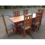 An Edward Dawson hardwood handmade dining set, the table with rectangular top on standards joined by