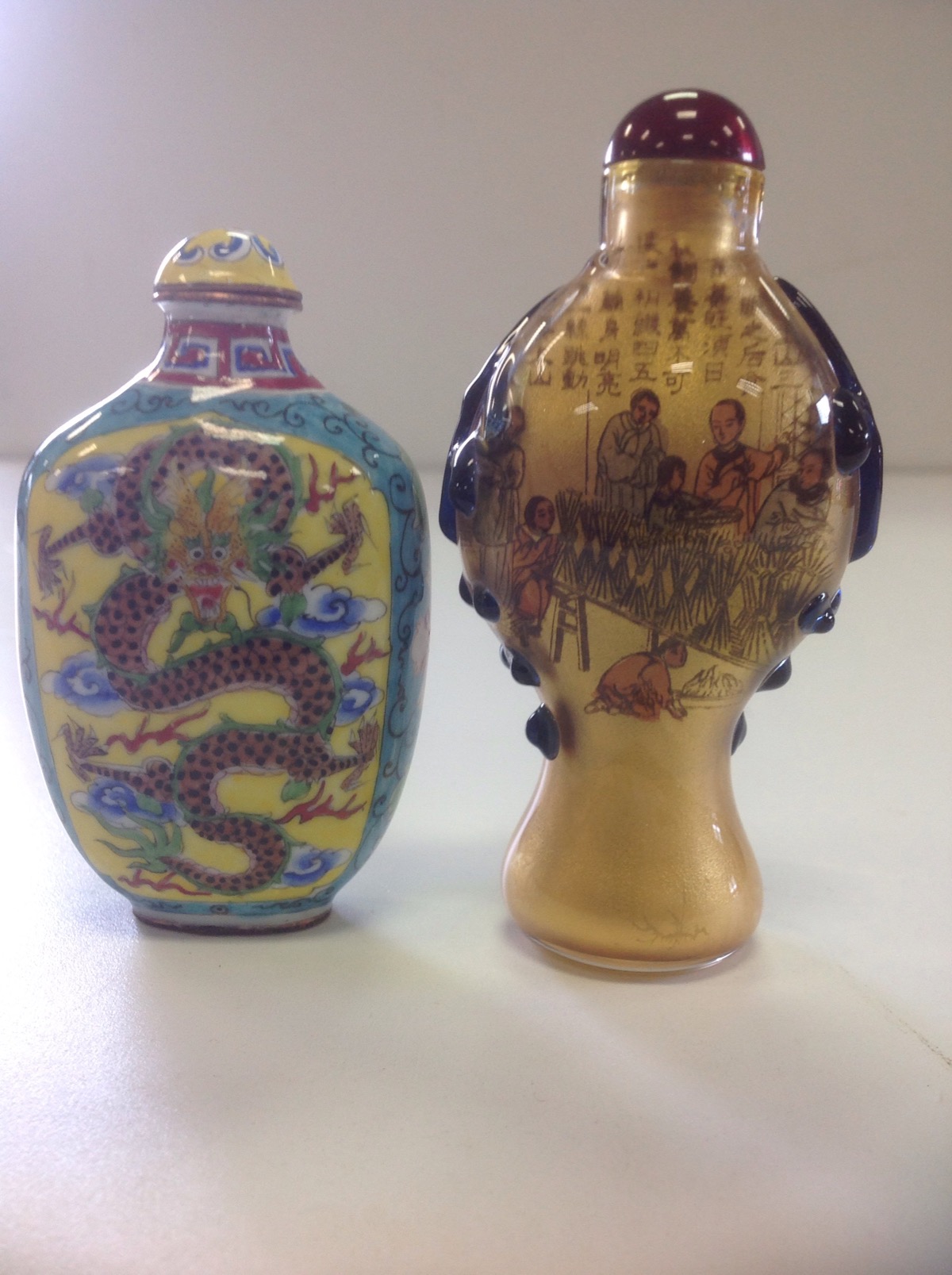 An interior painted Chinese glass snuff bottle of baluster shape, mounted with trailing green