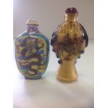 An interior painted Chinese glass snuff bottle of baluster shape, mounted with trailing green