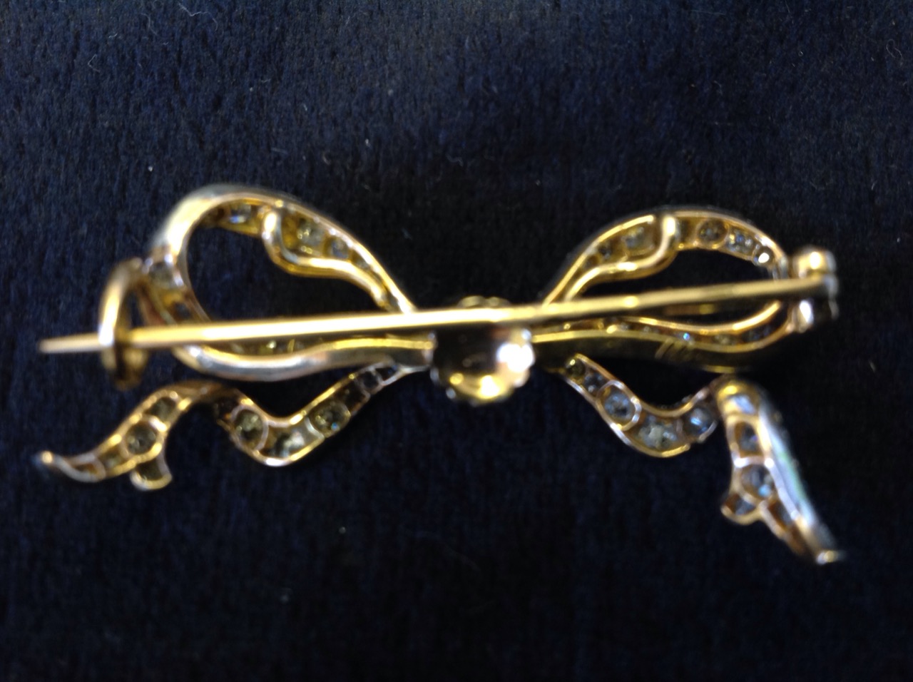 An 18ct gold diamond bow brooch, the ribbon bands set with diamonds around a central brilliant cut - Image 2 of 3