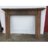 A large Georgian pine chimneypiece, with moulded mantelpiece above a fluted frieze having applied