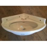 A LNE corner basin, the ceramic oval bowl with moulded overhang pierced for taps - marked LNE. (24.