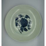 A blue & white early Ming style dish, decorated with peony flowers framed by blue lines, the cavetto