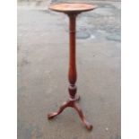 A mahogany jardiniere stand with circular tray top supported on an octagonal column carved with