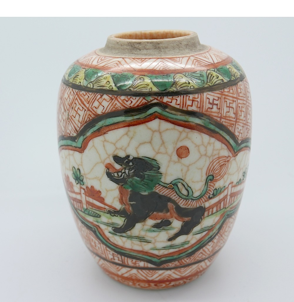 A twentieth century Chinese ginger jar decorated with two crackle glaze effect reserved panels of