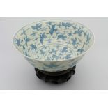 A Chinese blue & white bowl, raised on tubular foot, decorated with storks in flight framed by