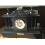 A large Edwardian polished slate mantleclock, the case of classical architectural form dated 1906,