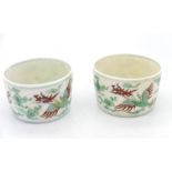 A pair of small Chinese bowls in red & green having two phoenix in flight to exterior, with