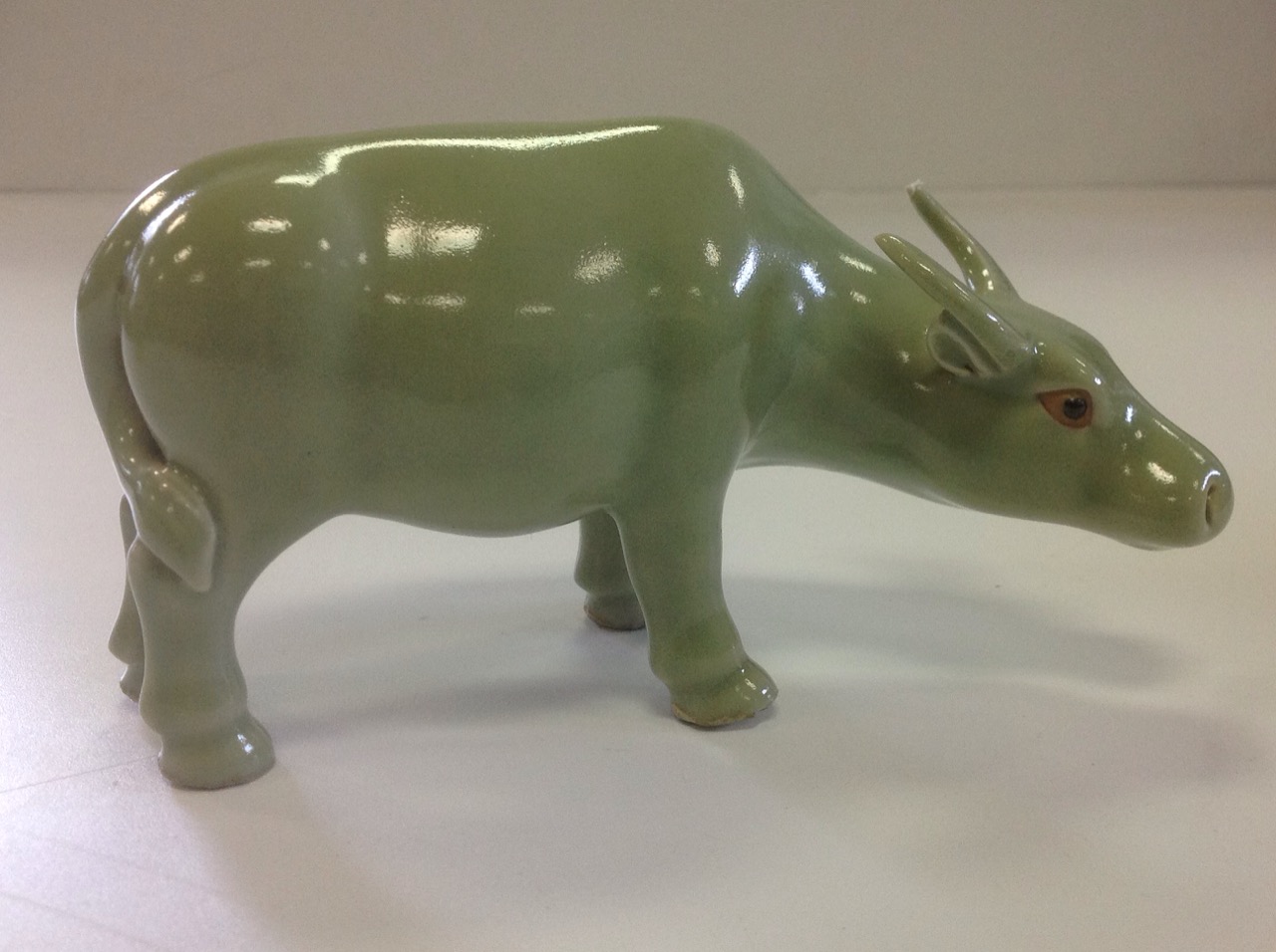 A pair of Chinese oxen, the animals with celadon glaze having black eyes and shaped horns. (6.5in) - Image 3 of 3