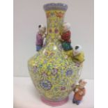 A Chinese republican style vase of baluster shape, mounted with four children, the yellow ground