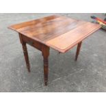 A Victorian mahogany pembroke table, having twin moulded drop-flaps above a frieze drawer mounted