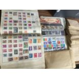 A stamp collection including a British Empire Album, many loose envelopes with stamps, first day