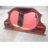 A Victorian mahogany overmantle mirror, the kidney shaped bevelled plate in frame mounted with three