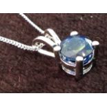 An 18ct white gold single stone sapphire pendant, the claw set stone on a fine chain weighing