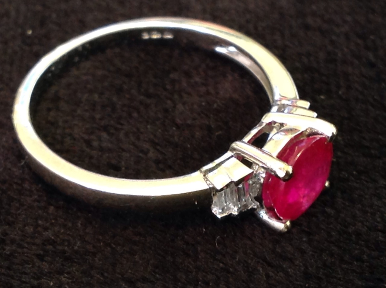 An 18ct gold ruby & diamond ring, the circular claw set ruby weighing three-quarters of a carat, - Image 3 of 3