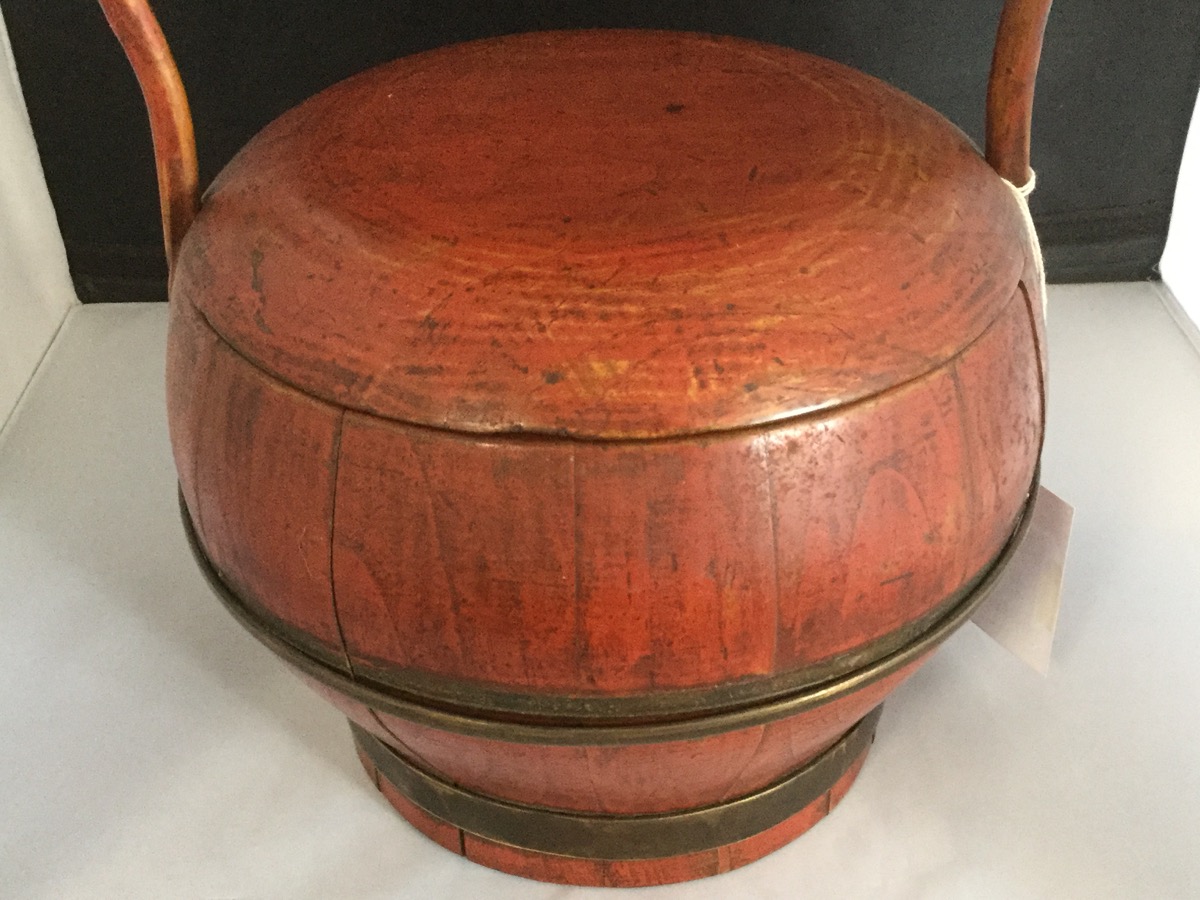 A Chinese red lacquered wood carrier and cover, with brass band mounts beneath a cane loop - Image 2 of 3