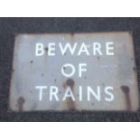 An enamelled railway sign with white on pale brown - Beware of Trains. (27in x 18in)