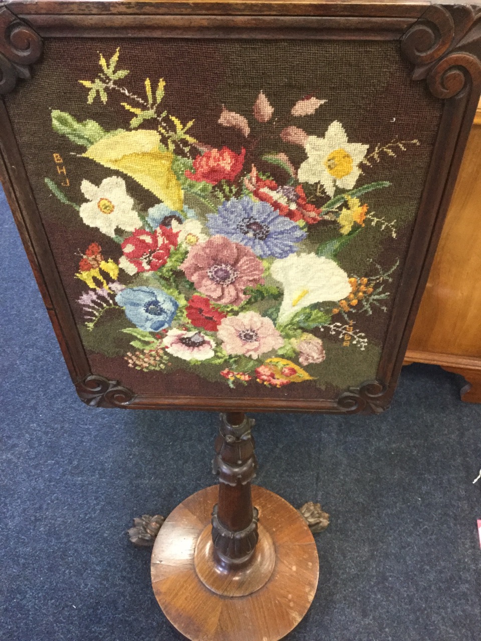 A George IV rosewood pole screen, with floral needlework panel in moulded frame having scroll carved - Image 3 of 3