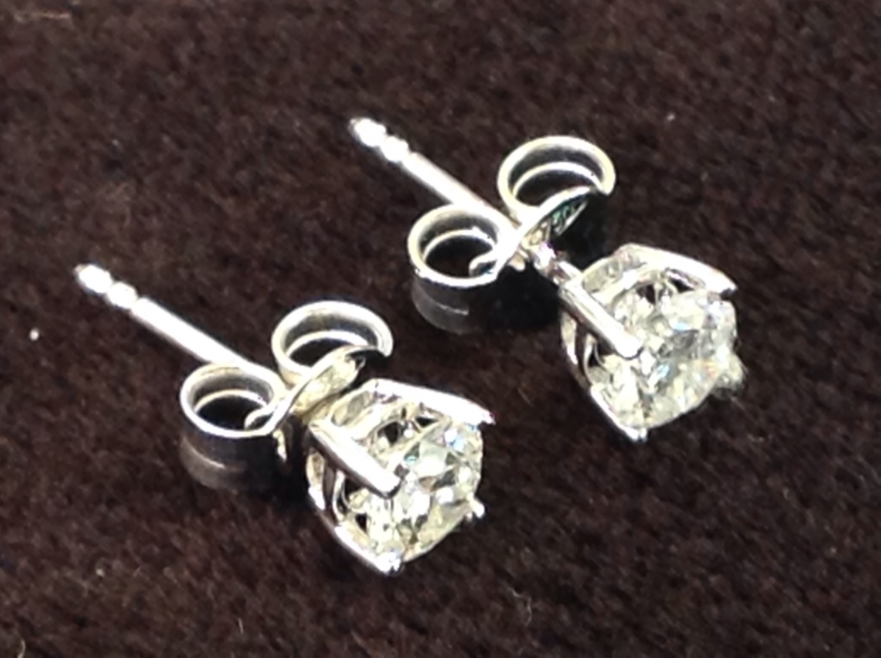 A pair of 18ct white gold diamond stud earrings, the fine claw set stones weighing over half a