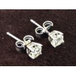 A pair of 18ct white gold diamond stud earrings, the fine claw set stones weighing over half a