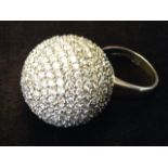 A palladium diamond ball ring, the stones of nearly 15 carats set as a small ball, mounted on a