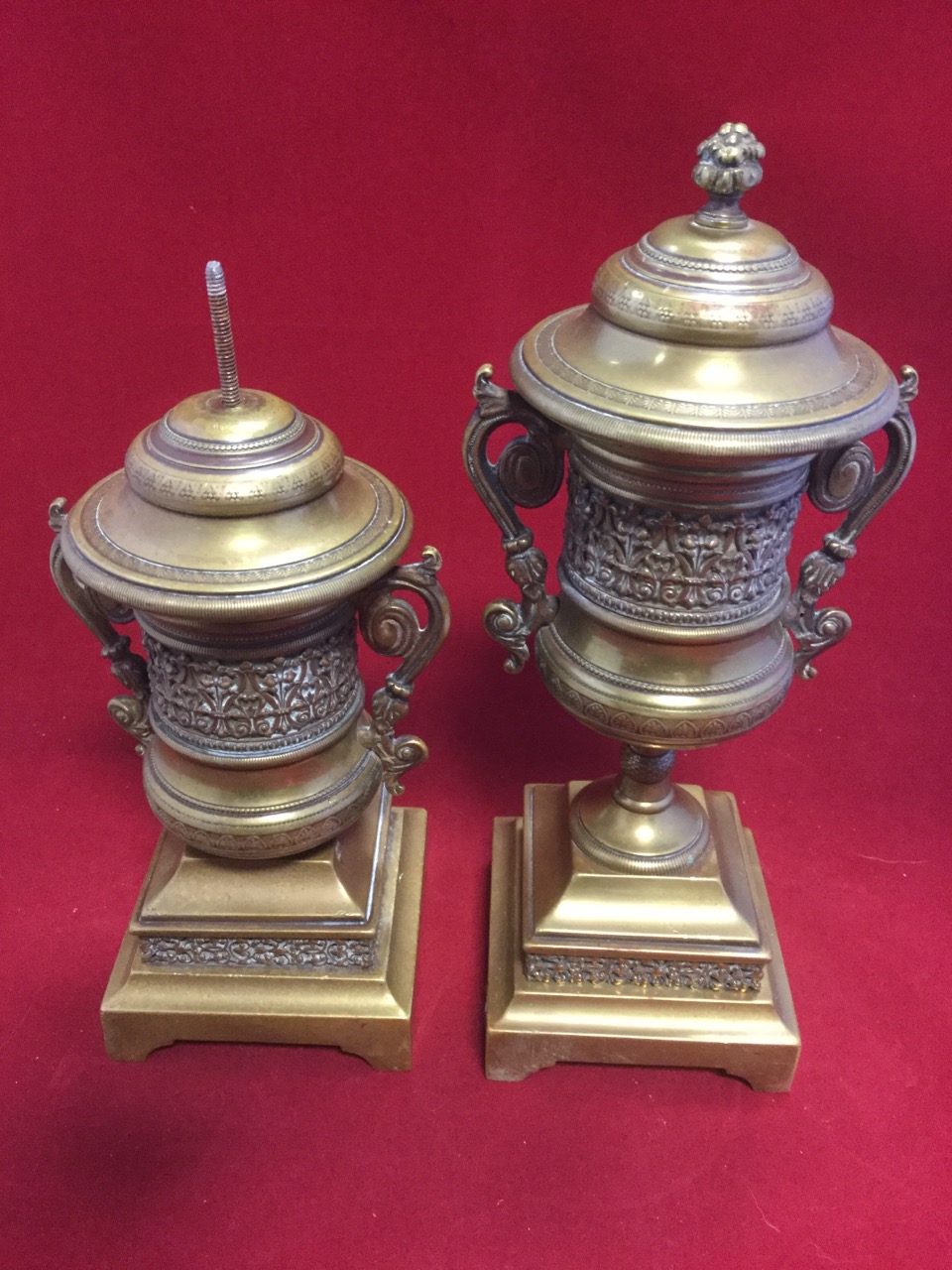 A pair of nineteenth century brass urns, of campana shape with scrolled handles, having applied