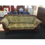 A William IV mahogany sofa, with cushion moulded rounded back and scrolled arms carved with