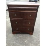 A Victorian mahogany chest of drawers with later alterations, having rectangular top above a cushion