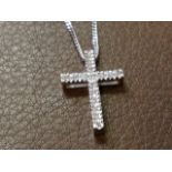 A small 9ct gold diamond crucifix, the cross set with diamonds, mounted on a fine chain. (9.5in)
