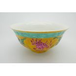 A Chinese dragon bowl decorated with turquoise greek key band above raised dragons carved in