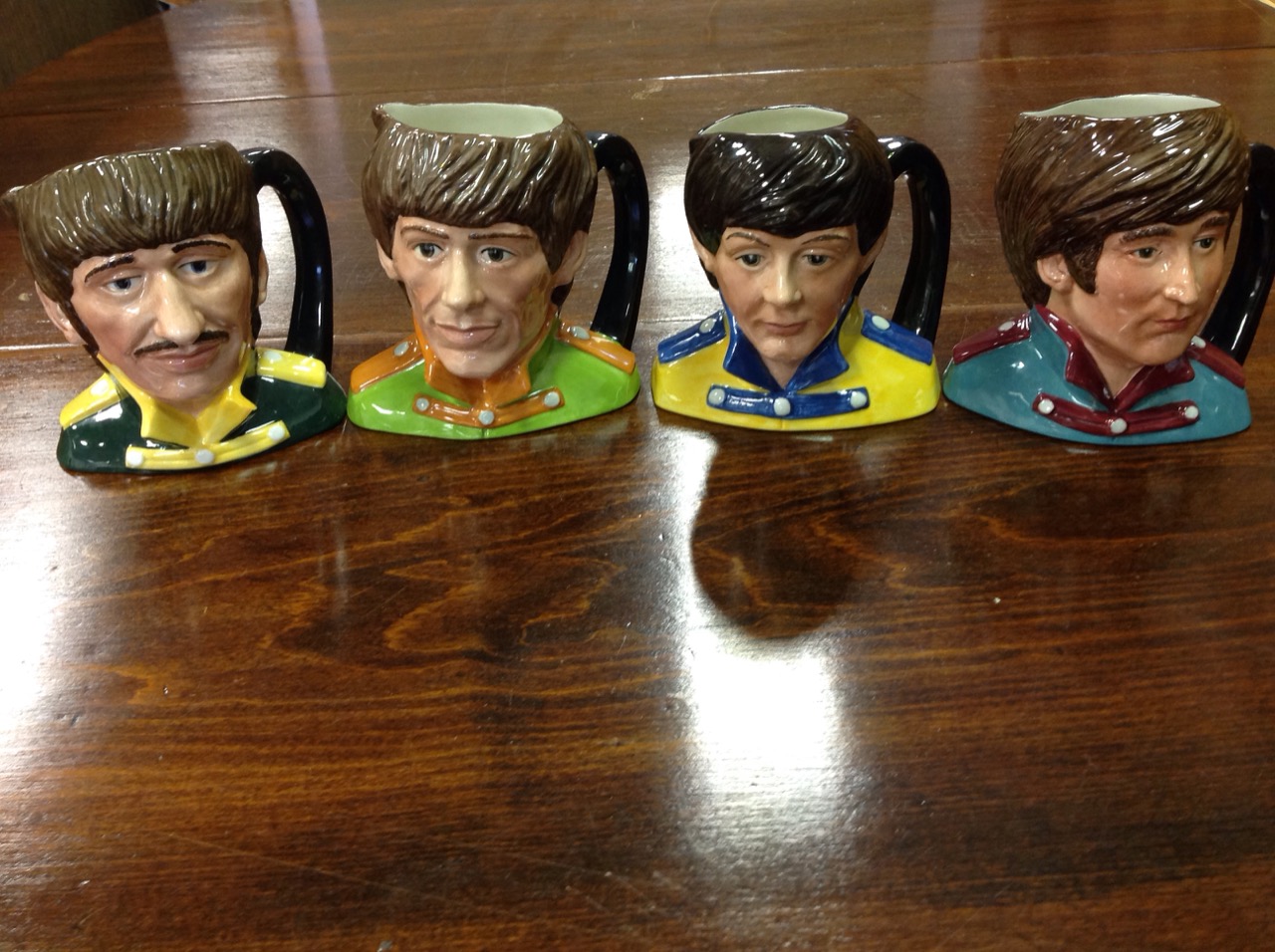 A set of four Royal Doulton Beatles toby jugs - Ringo, Paul, George and John, modelled by Stanley