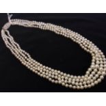 A pearl choker necklace, the graduated pearls in four rows, joined by oval panel clasp set with