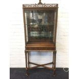 A Chippendale style mahogany display cabinet, with fretwork gallery above glazed display case having