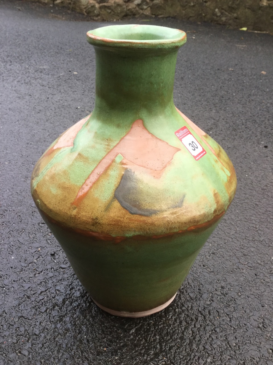 A large tapering terracotta studio pottery vase with tubular neck & moulded rim, decorated with