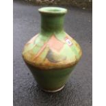 A large tapering terracotta studio pottery vase with tubular neck & moulded rim, decorated with