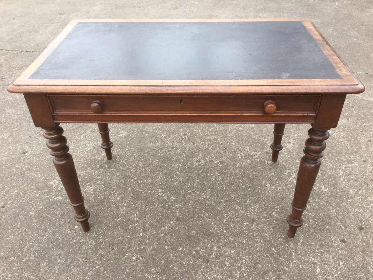 A Victorian mahogany writing table, having moulded skiver top above a panelled frieze drawer,