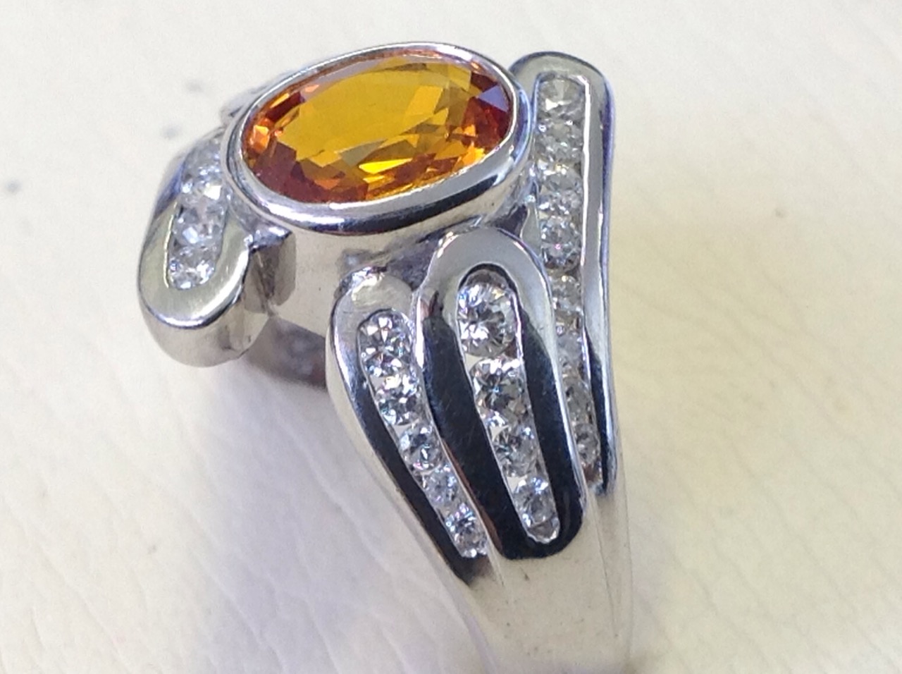 An 18ct gold oval yellow sapphire & diamond crossover ring, the central bezel set stone of 1.42 - Image 2 of 3