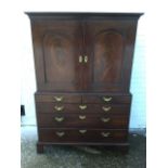 A Georgian mahogany estate cupboard, with moulded cornice above arched doors enclosing a fitted