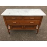 A marble topped washstand, with two short & a long drawer above cupboards, supported on turned
