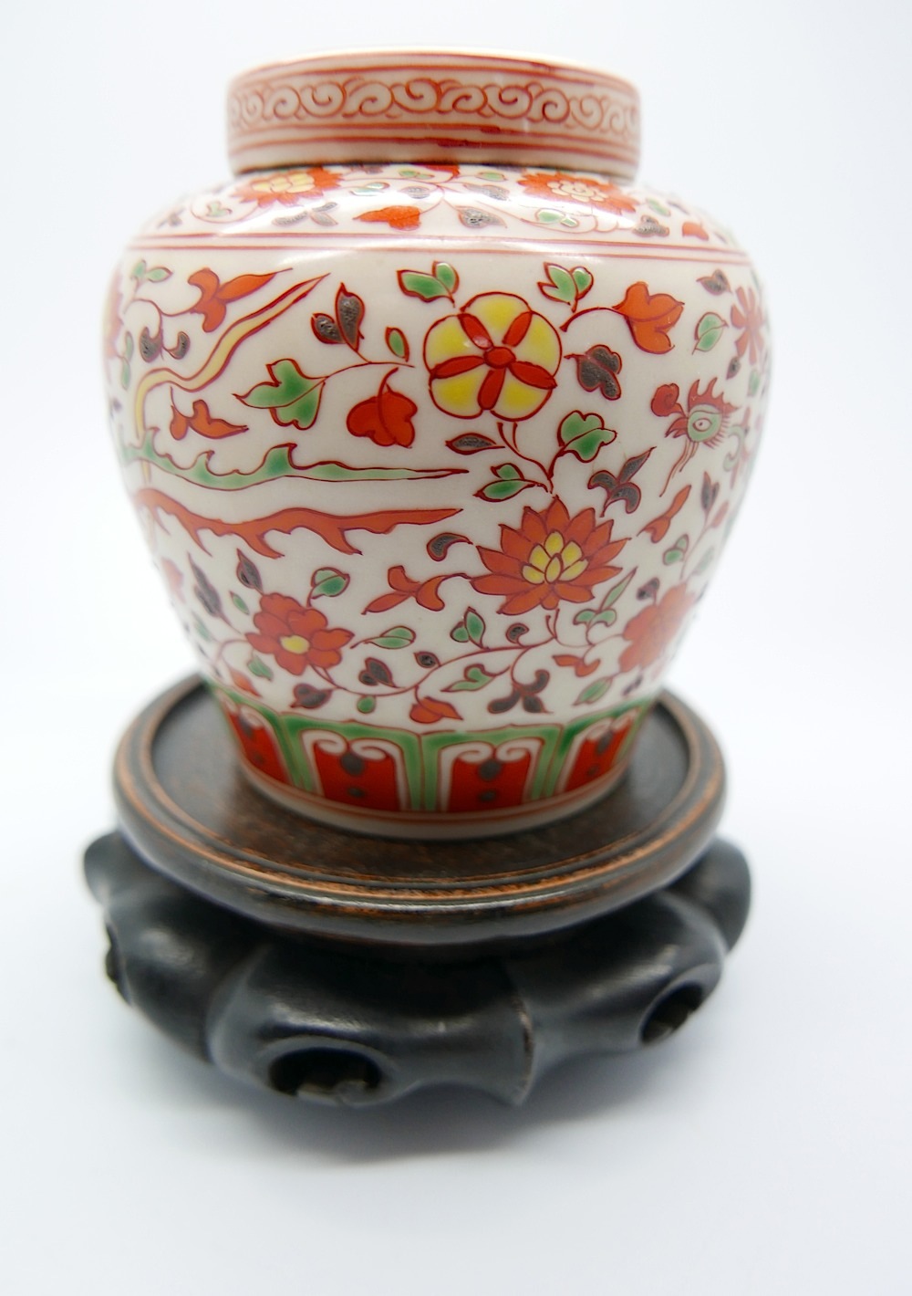 A small Chinese jar and cover, delicately enamelled with phoenix and a foliate pattern underglaze to